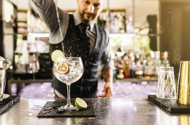 Barman is making cocktail at night club. Expert barman is making cocktail at night club.